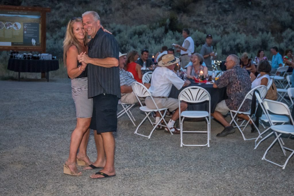 A couple dances while others chat over wine as evening falls at the Osoyoos Desert Centre during Saturday evening's Romancing the Desert. (Richard McGuire photo)