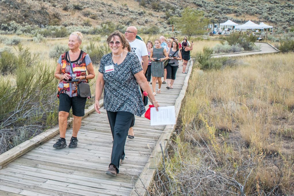 Lee McFadyen, president of the Osoyoos Desert Society, leads a group of guests on a guided tour along the boardwalk at Romancing the Desert on Saturday evening. (Richard McGuire photo)