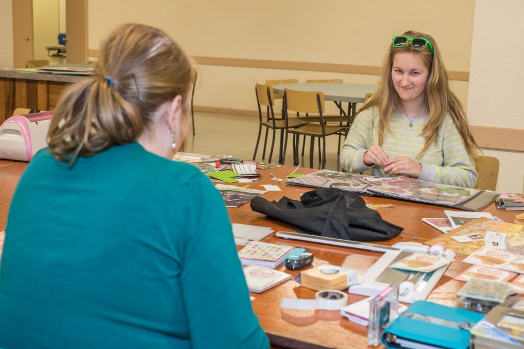 While Roxanne Anderson (left), worked on making tea party invitations, Teagen Aspell worked on a scrapbook about the Osoyoos Royalty at the Osoyoos Baptist Church on Saturday. Participants rented tables to do their work as a fundraiser for Desert Sun Counselling's Men's Counselling Program. (Richard McGuire photo)
