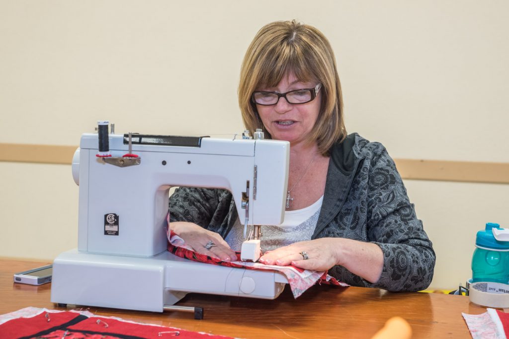 Terri Postnikoff, of Osoyoos, worked on quilting some placemats at the Osoyoos Baptist Church on Saturday. Participants rented tables to do their work as a fundraiser for Desert Sun Counselling's Men's Counselling Program. Postnikoff is just beginning in quilting, but she also does scrapbooking and cards. (Richard McGuire photo)