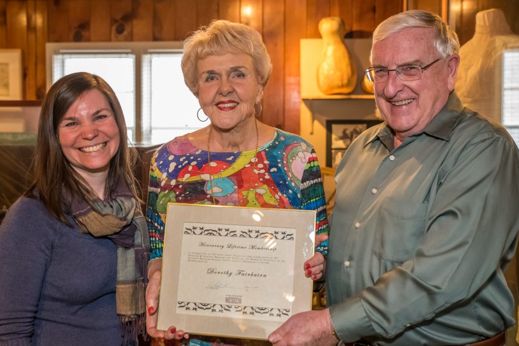 Dorothy Fairbairn (centre) holds the honorary lifetime membership to the Osoyoos Museum that she was presented with by manager Kara Burton and board president Mat Hassen. (Richard McGuire photo)