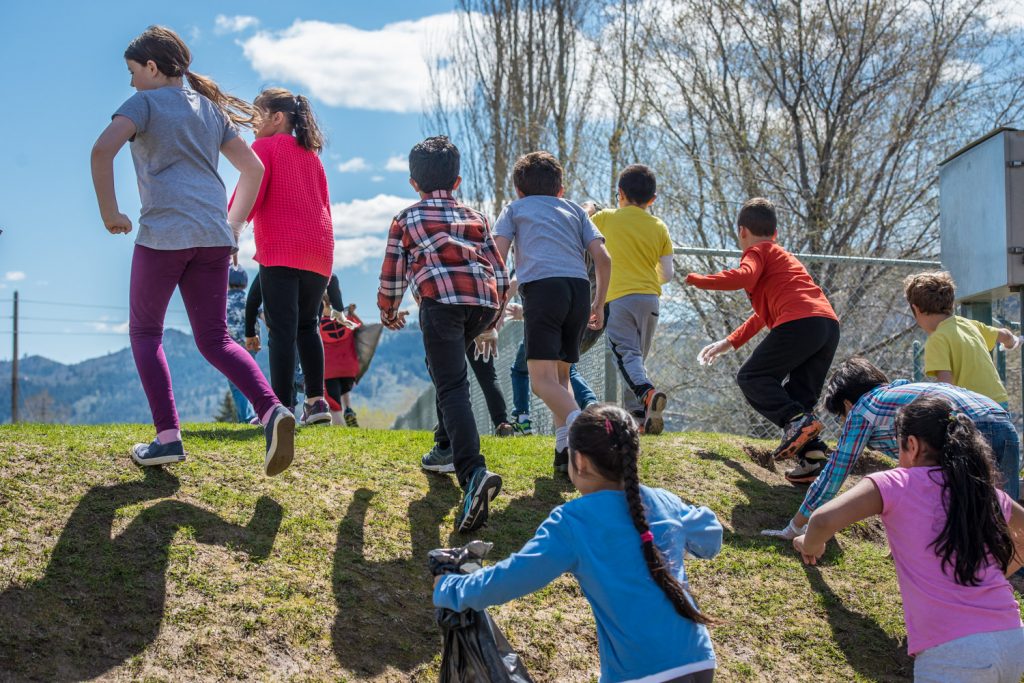 Osoyoos Elementary School students celebrated Earth Day on Friday by fanning out around Osoyoos and cleaning up litter. Julie Dias' grades 2-3 class, pictured here, was assigned to clean up the school yard. (Richard McGuire photo)