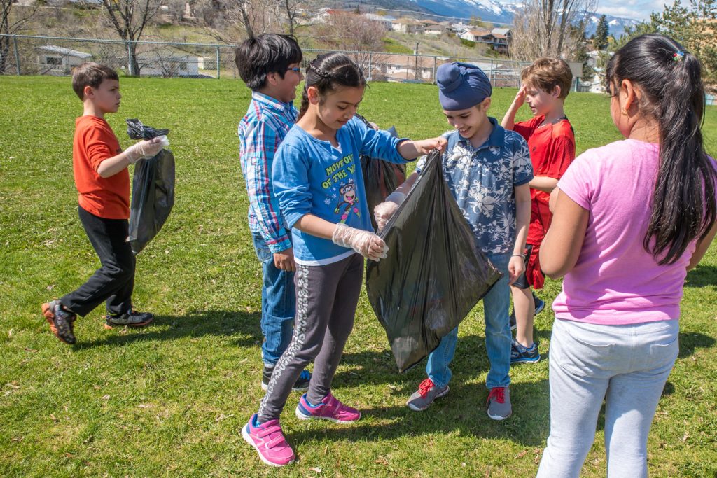 Osoyoos Elementary School students celebrated Earth Day on Friday by fanning out around Osoyoos and cleaning up litter. Julie Dias' grades 2-3 class, pictured here, was assigned to clean up the school yard. (Richard McGuire photo)