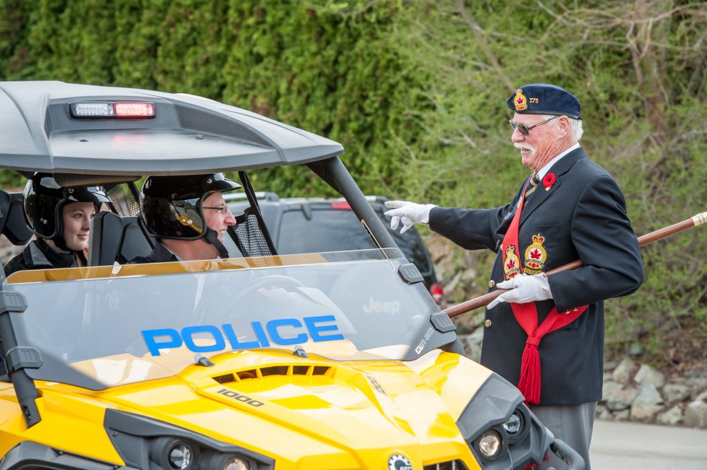 Lew Taylor (right) of the Royal Canadian Legion branch 173 chats with Sgt. Kevin Schur, commanding officer at the Osoyoos RCMP Detachment before the start of the Easter parade. Schur was driving the new all-terrain vehicle the detachment has acquired, which can pursue criminals or carry out rescues in remote locations off roads. (Richard McGuire photo)