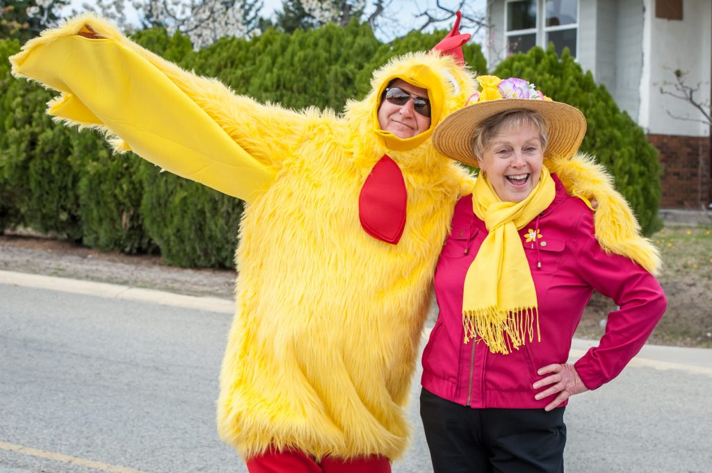 A yellow and red chicken resembling Osoyoos Mayor Stu Wells poses with Councillor Sue McKortoff, dressed in red and yellow. The two walked the length of the Easter parade route Saturday while fellow council members Michael Ryan and C.J. Rhodes drove. (Richard McGuire photo)