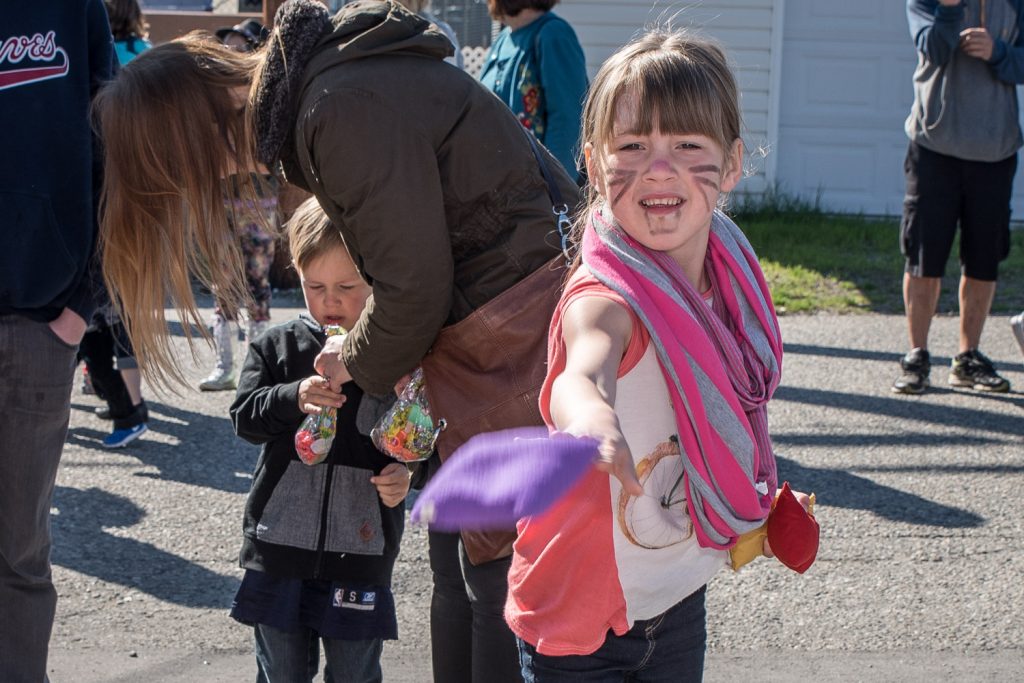 Marai Potschka, 6, of Langley tosses a bean bag to try to get it into the mouth hole of a painted clown. (Richard McGuire photo)