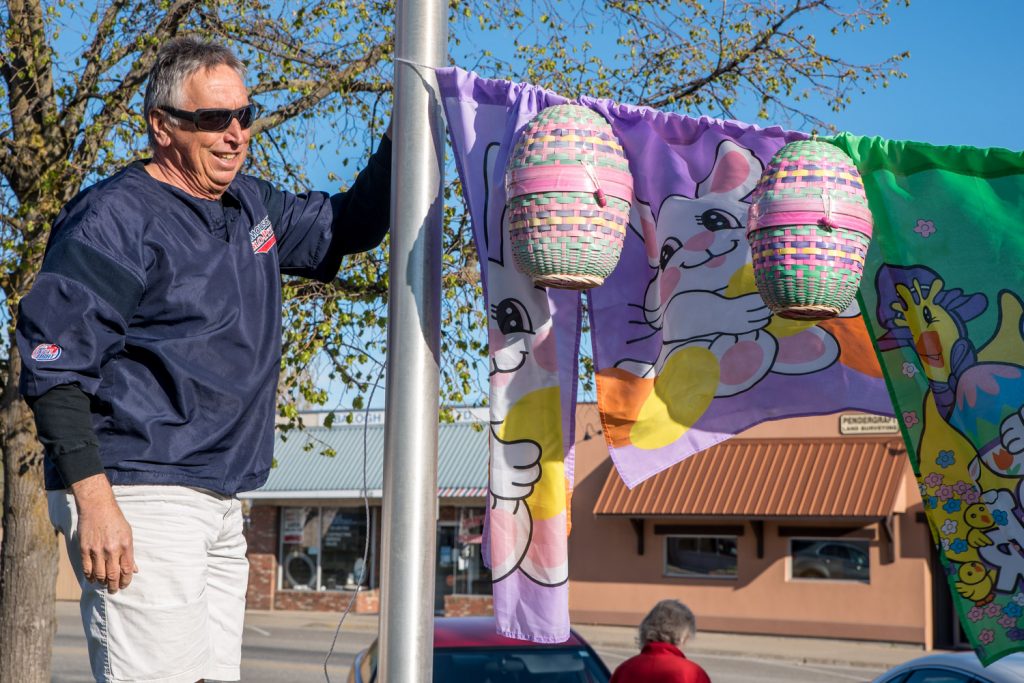John Katerenchuk hangs Easter decorations at the town centre as Easter Eggstravaganza gets underway on Saturday. (Richard McGuire photo)