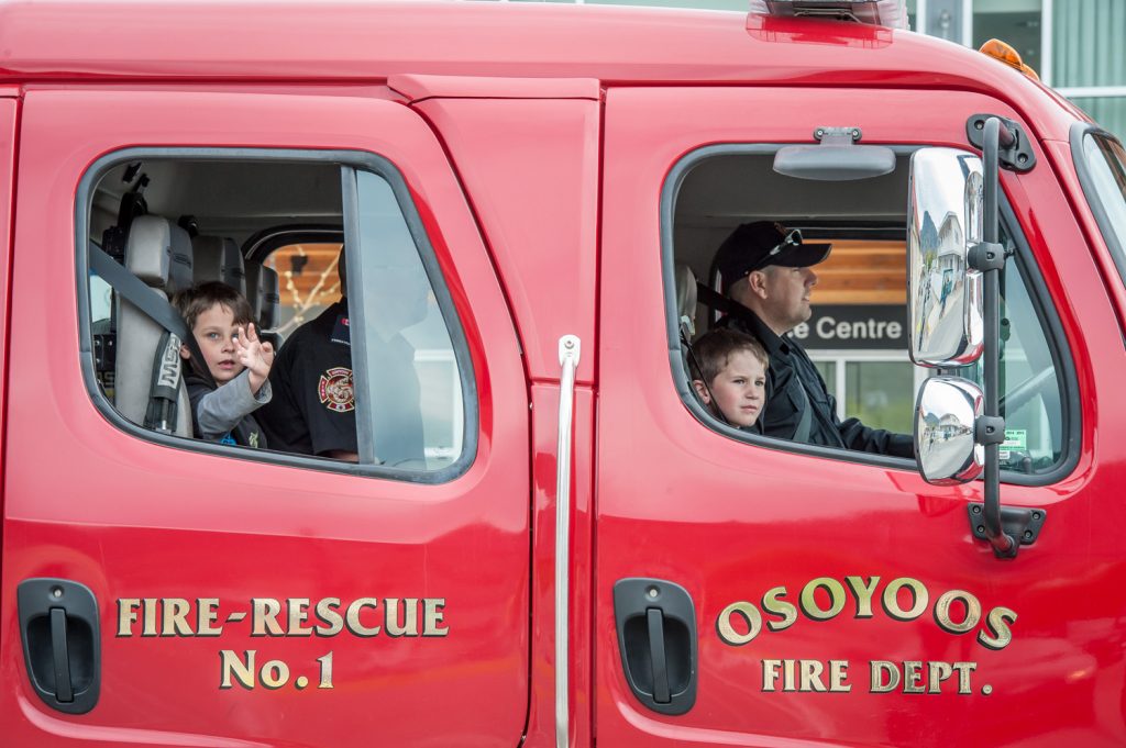 According to tradition, the Osoyoos Fire Department follows at the end of the parade. Unlike the Canada Day parade, they did not use their hoses in the cooler weather on Saturday. (Richard McGuire photo)