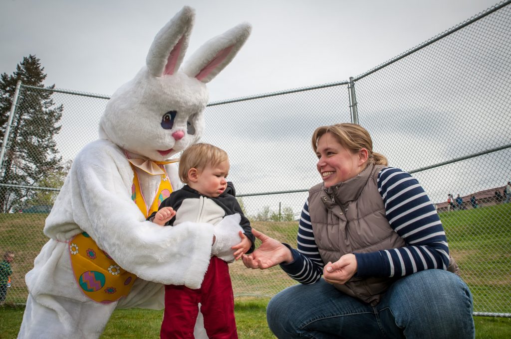 Little Reid Dynneson doesn't quite know what to make of being hugged by the Easter Bunny, so his mother Sarah Dynneson reassures him. The bunny sounded a lot like Ken Baker, the ad salesperson at the Osoyoos Times. (Richard McGuire photo)