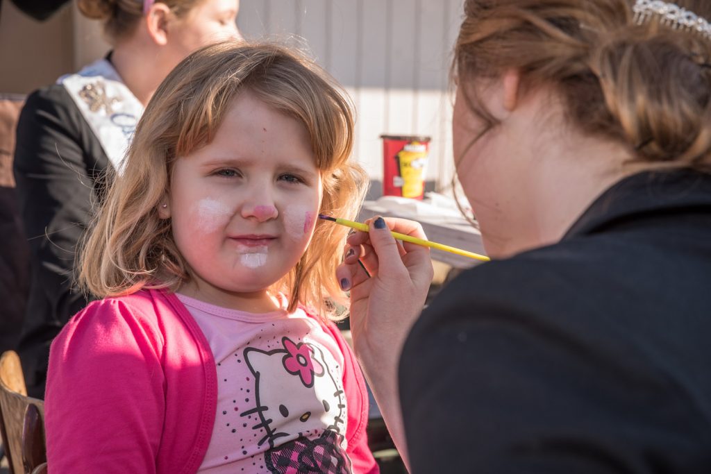 Katie Kubb, 5, from Mission got her face painted by Ali Hutter, an Osoyoos Royalty princess. (Richard McGuire photo)