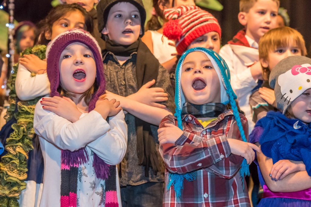 Brooklyn Pires (left) and Noah King open wide to sing Crunchy Snow and Swoosh when the Grades 1 and 2 performed. (Richard McGuire photo)