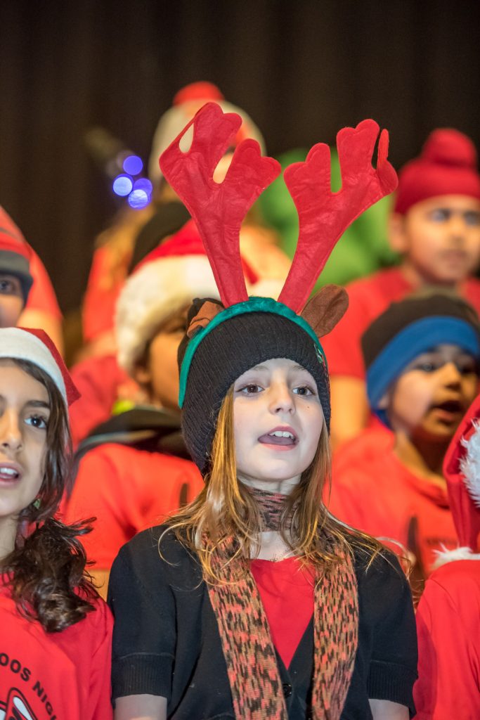 Meadow Stamberg wore a nice set of reindeer antlers when the Grades 3 and 4 classes performed at Snowtastic. (Richard McGuire photo)