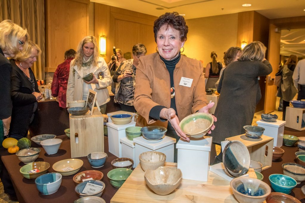 Osoyoos Potter Dianne Hughes shows one of the bowls her club made for Desert Sun's Empty Bowls fundraiser. Guests got to take home the bowls after tasting gourmet soups made by a dozen of the area's best chefs. (Richard McGuire photo)