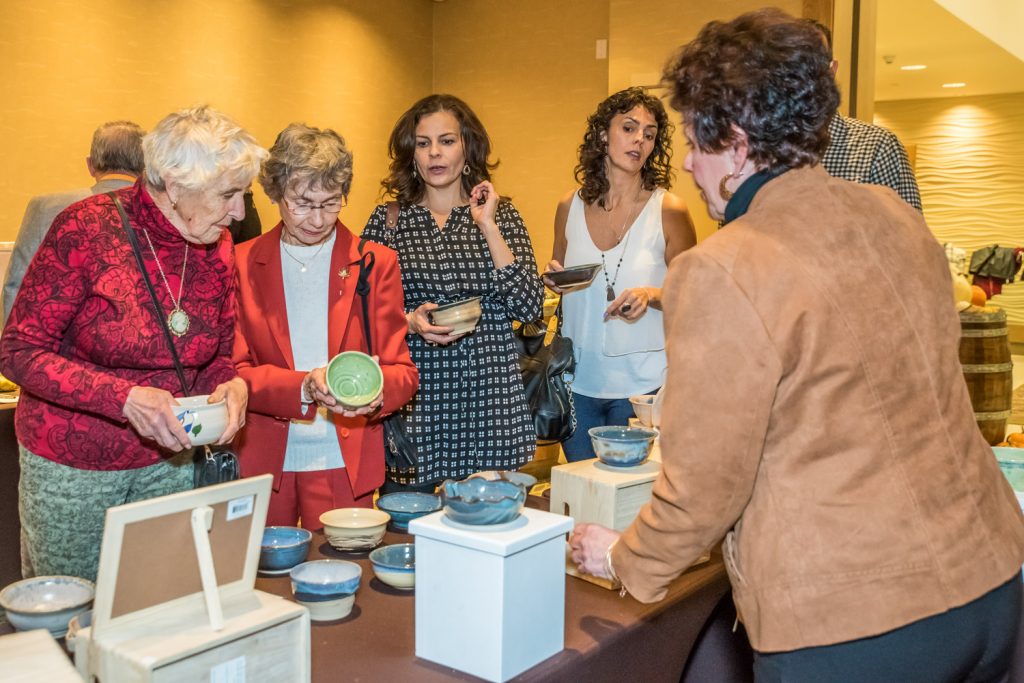 Guests choose ceramic bowls made by members of the Osoyoos Potters Club at Desert Sun's Empty Bowls fundraiser. Guests got to take home the bowls after tasting gourmet soups made by a dozen of the area's best chefs. (Richard McGuire photo)
