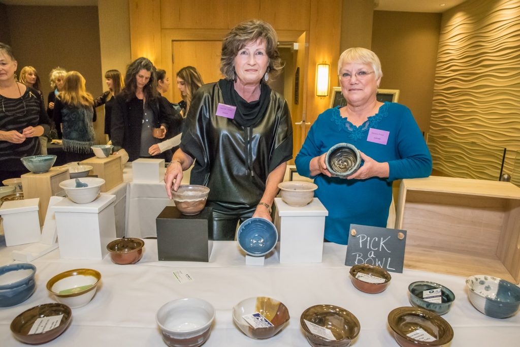 Osoyoos Potters Darlene Fillion (left) and Gabriele Villecourt were volunteering at a table where guests could pick a custom made ceramic bowl when the arrived at the Empty Bowls Fundraiser on Friday. (Richard McGuire photo)