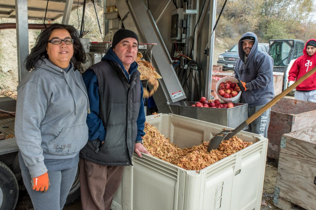 Anna Relvas pours a glass of cider while her husband Jack looks on. The couple officially opened Faustino Estate Cidery's roadside outlet on Friday, where they sell three varieties of hand-crafted cider that they make from their own apples. They are located on Highway 97 just north of Osoyoos immediately north of the Red Barn. (Richard McGuire photo)
