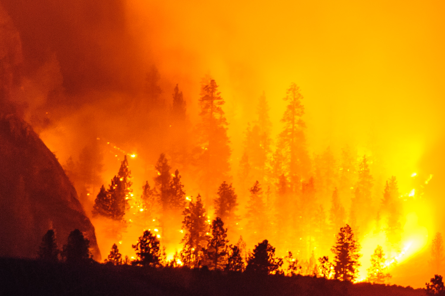 Fires burn at night with an eerie glow through thick smoke on the east side of Osoyoos Lake. The fires were a controlled burn by the Osoyoos Indian Band to remove excess flammable plant material and to improve the habitat for wildlife. (Richard McGuire photo)