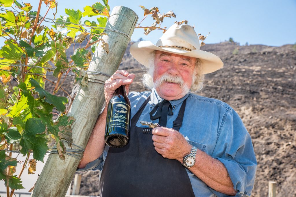 As a raging wildfire blew down to his property line Friday night, Bruce Fuller, owner of Rustico Farms and Cellars, stayed behind to protect his property. As he watched the fire, he decided to pour himself a glass of Last Chance, but realized he didn't have a cork screw. He eventually found one. His vines, just a few feet from scorched ground and his winery were spared. (Richard McGuire photo)