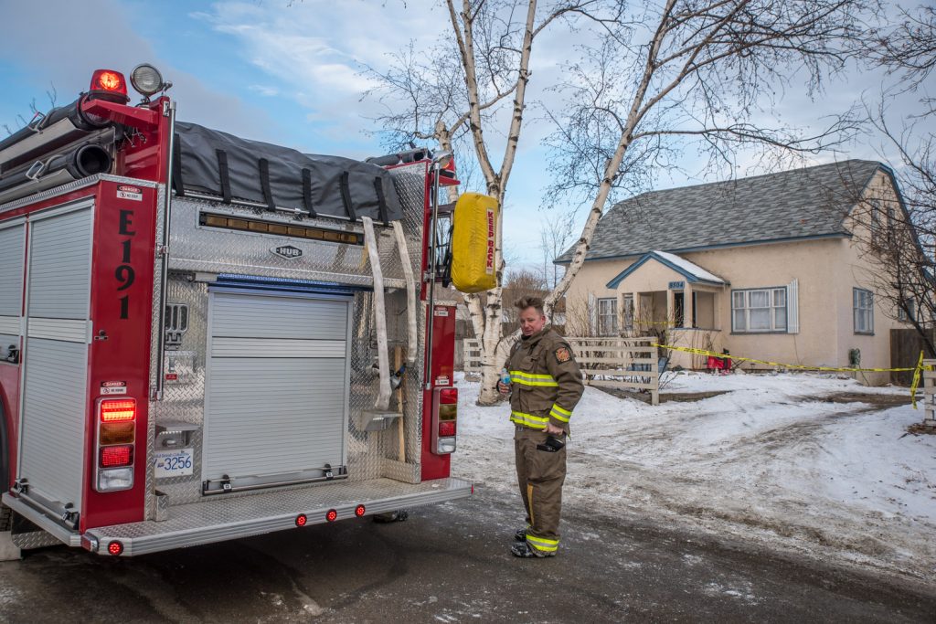 Osoyoos firefighters were called to a blaze Tuesday morning just after 6 a.m. at 8504 70th Avenue. Pictured, firefighter John Jorgens takes a break after the fire was extinguished. Fire Chief Rick Jones said the cause of the fire is still under investigation. The fire originated in the basement, Jones said, and there was extensive damage in the basement and around the heating area. There were no injuries. (Richard McGuire photo)