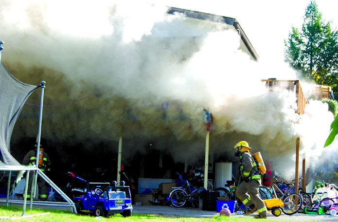 fireoctober09web Firefighters battle a fire at a home on 26th Avenue on the morning of Oct. 8. The seven members of the family living at the house at the time have found a new home to rent, but is in need of a number of items. Photo by Laurena Weninger - Click on picture for larger image