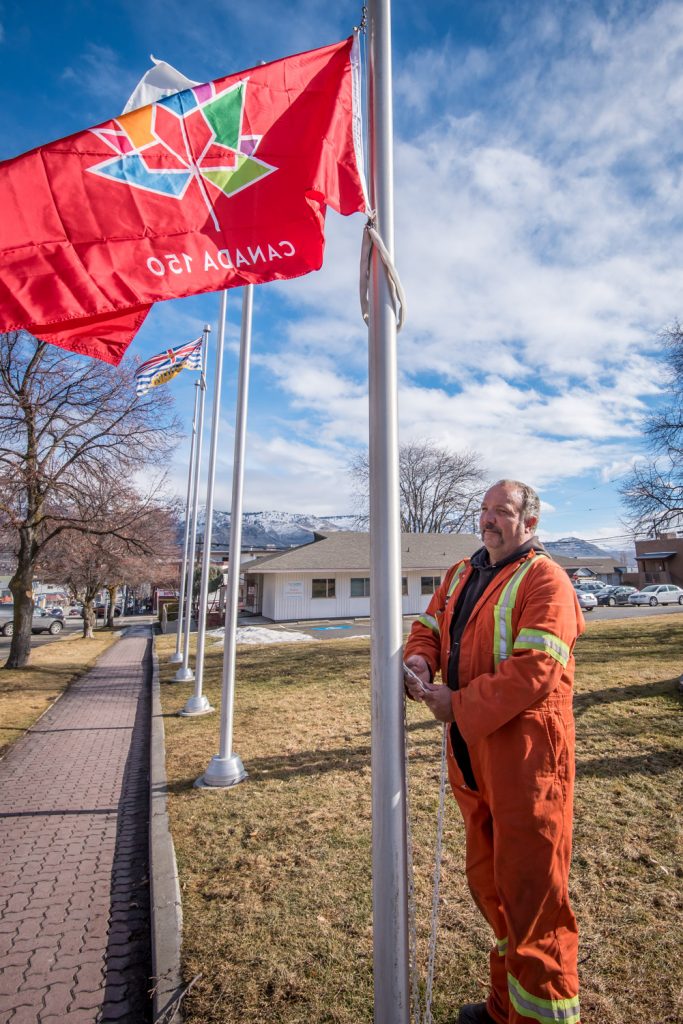 Town of Osoyoos employee Frank Zandvliet raised two Canada 150 flags on poles in front of the town hall on Friday. This year marks the 150th anniversary of Confederation in 1867 and there will be many events throughout the year to commemorate Canada’s sesquicentennial. (Richard McGuire photo)