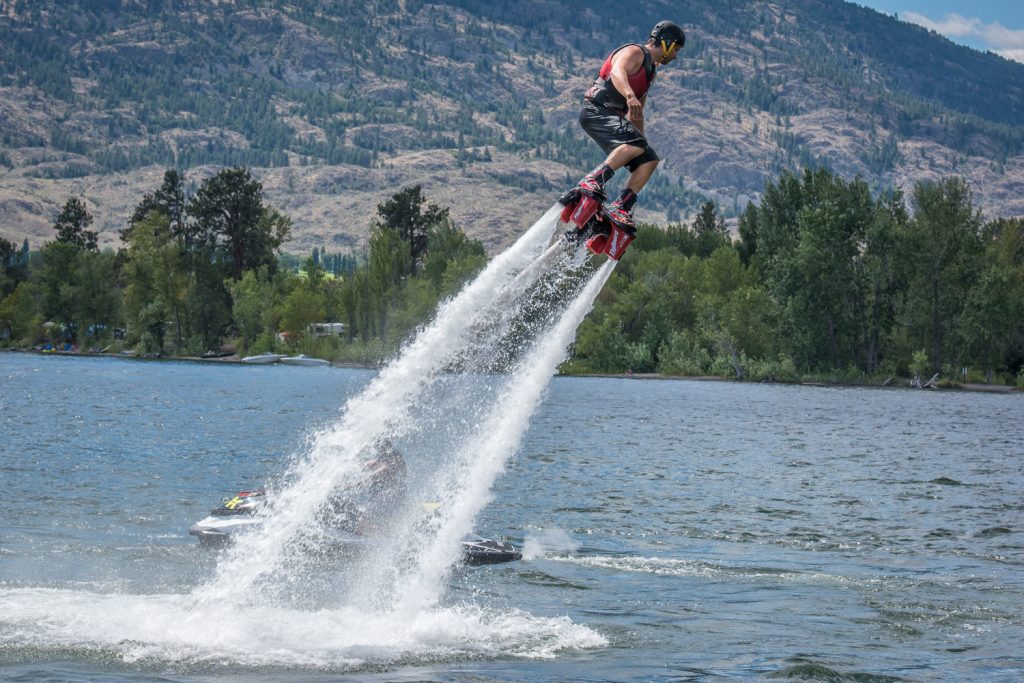Curtis Pangrass flies and flips through the air propelled by powerful jets of water in the sport of flyboarding. A member of Team CanFly, Pangrass, from Edmonton, did demonstrations on the weekend at Walnut Beach Resort. The event was arranged by Travis Blacklin,  proprietor of Canadian Jet Pack Adventures, who is operating a flyboarding concession at the resort again this summer. (Richard McGuire photo)