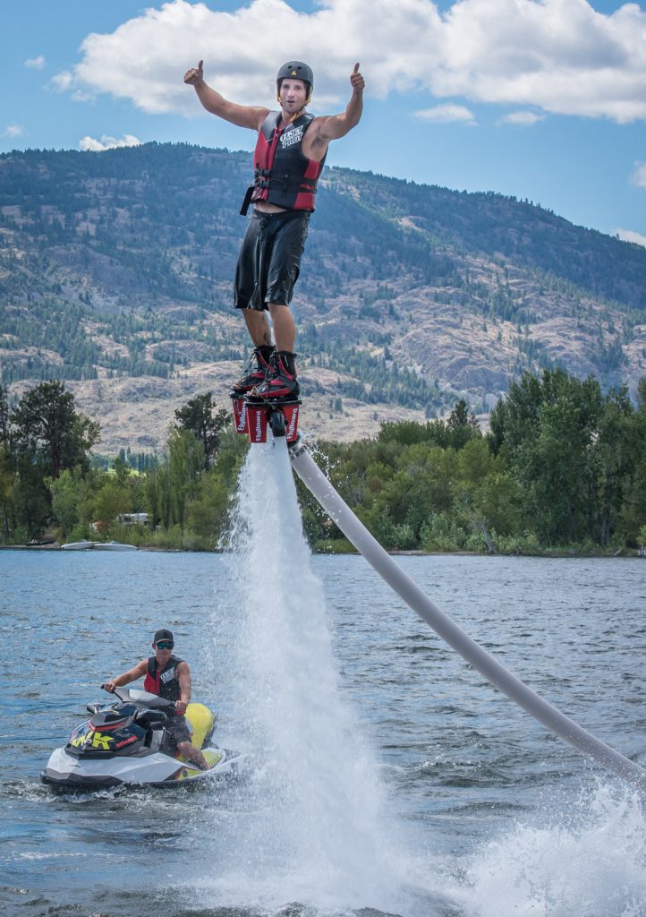 Travis Blacklin flies through the air, propelled by a jet of water, as Paul Reid operates a watercraft in the exciting sport of flyboarding. (Richard McGuire photo)