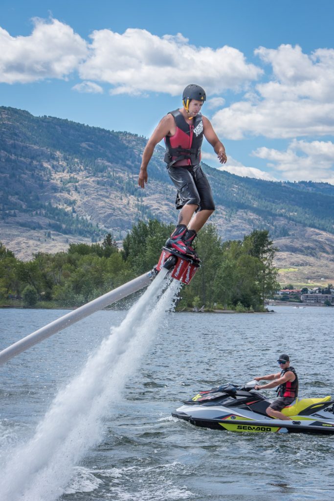 Travis Blacklin flies through the air, propelled by a jet of water, as Paul Reid operates a watercraft in the exciting sport of flyboarding. (Richard McGuire photo)