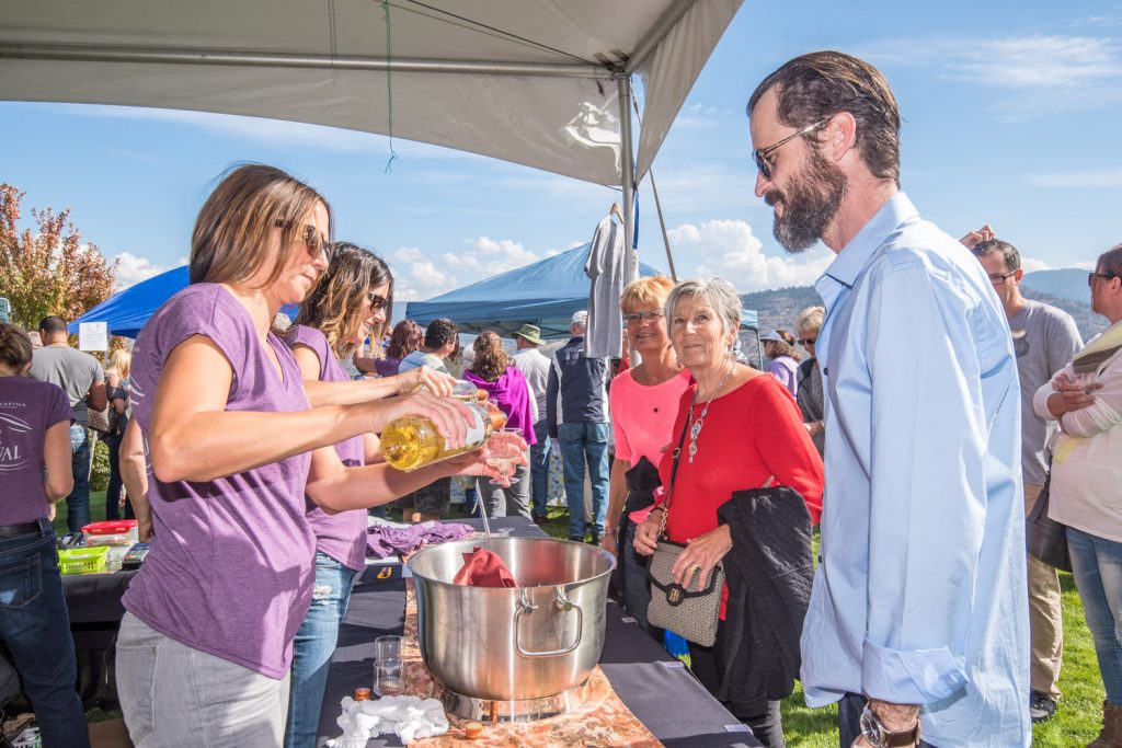 Melissa McLaughlin pours a glass of white wine at Hester Creek's fifth annual Garlic Festival on Saturday. (Richard McGuire photo)