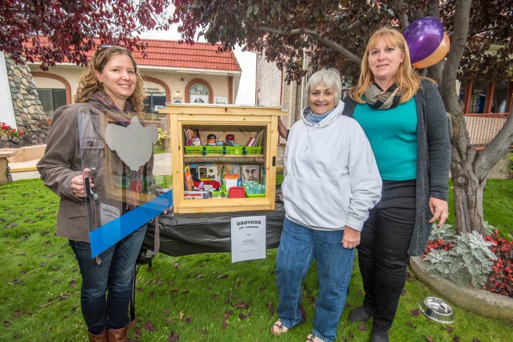 The new Osoyoos Gift Cupboard was unveiled in October next to the Osoyoos Art Gallery. The cupboard was to be mounted to a permanent stand later in the week. It contains donated items ranging from toiletries to notebooks and playing cards and people will be able to help themselves to what they need. The Gift Cupboard had the unanimous support of Osoyoos Town Council and it received a $500 grant from the Community Foundation of South Okanagan-Similkameen. Pictured are the three women responsible for the project, (from left) Jen Shiels, Gaye Horn and Brenda Dorosz. (Richard McGuire photo)