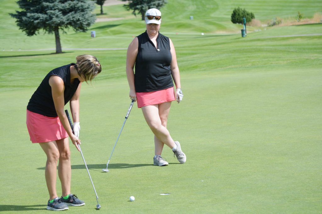Diane Butt (left) and Karen Bunner from Osoyoos were among 124 ladies who competed in the "Swinging Skirts" golf tournament at Nk'Mip Canyon Desert Golf Course in Oliver last Friday. (Lyonel Doherty photo)