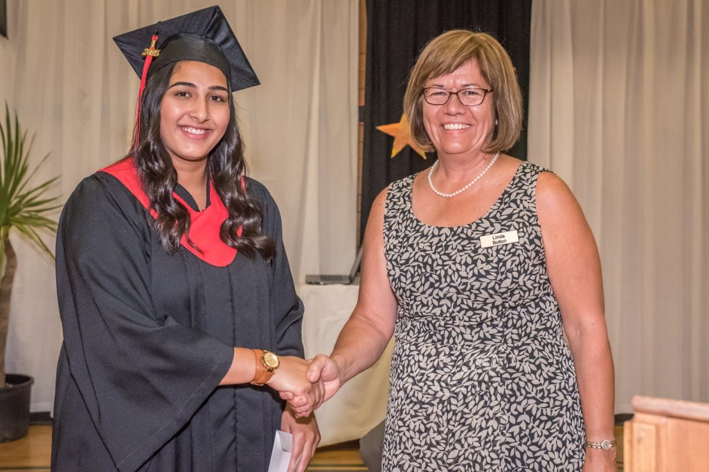 Linda Bolton (right), the managing director of the Osoyoos Times, had the honour of presenting the Osoyoos Times Scholarship to Amneet Brar Thursday night at Osoyoos Secondary School's graduation ceremony. This was just one of a number of scholarships and bursaries given to deserving students by local businesses, organizations and individuals. (Richard McGuire photo)