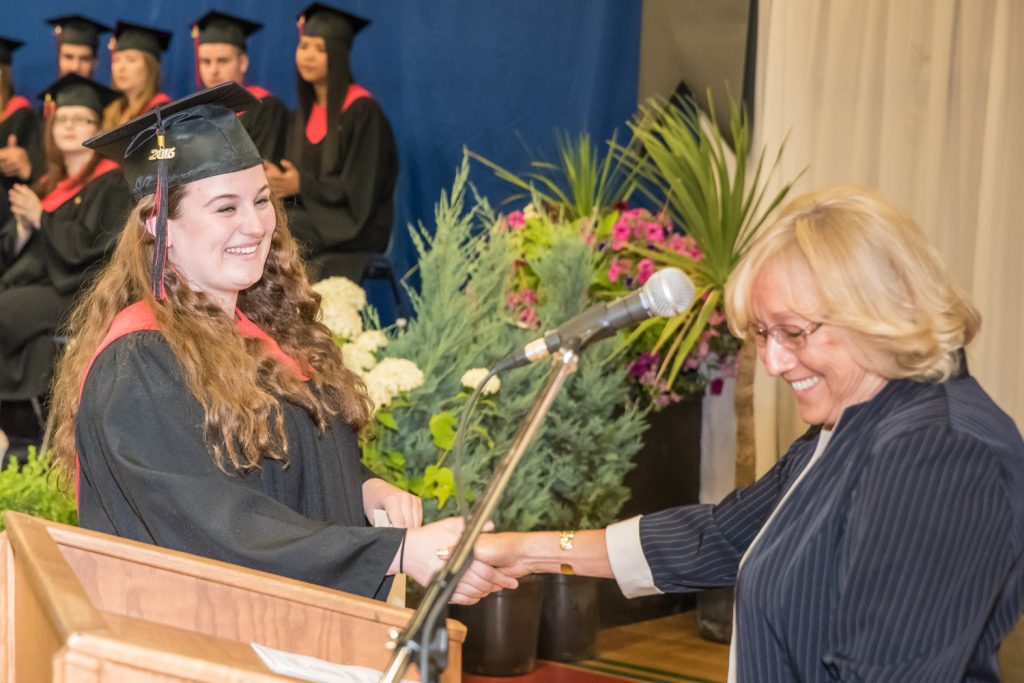 Judy Miller-Bennett, outgoing president of the Rotary Club of Osoyoos, presents a scholarship on behalf of her club to Kelsey Loura. (Richard McGuire photo)