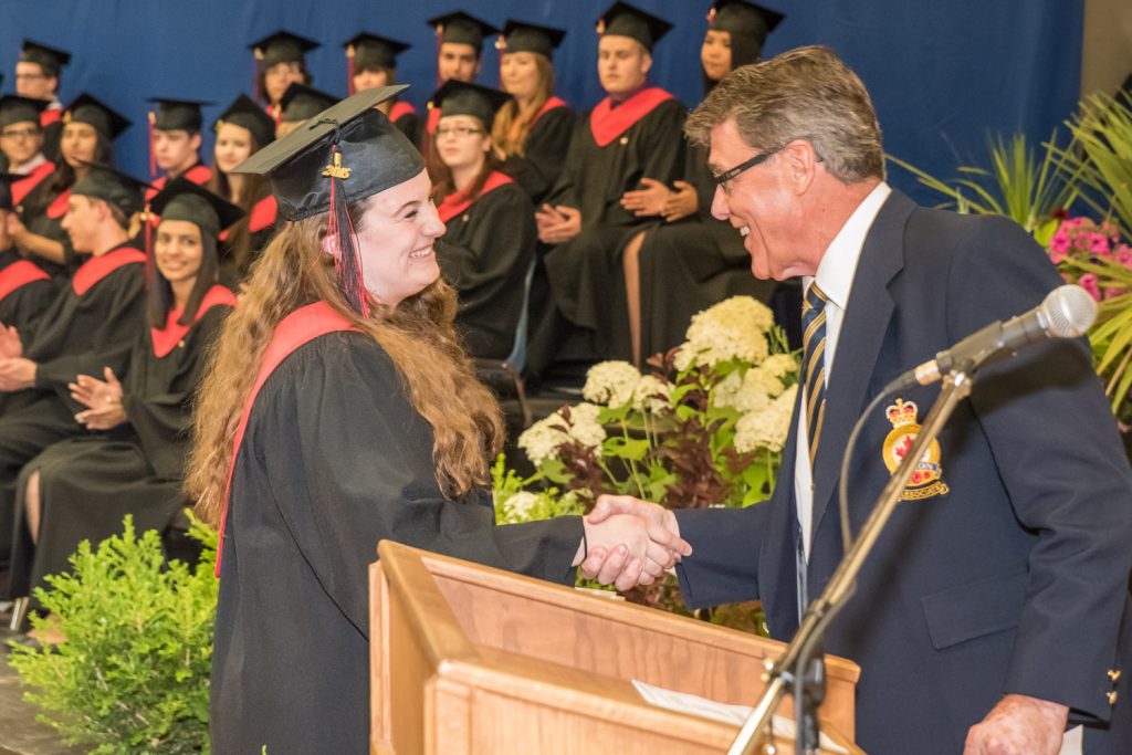 Garry Sutton, representing the Royal Canadian Legion Branch 173, presents an award on behalf of the Legion to Kelsey Loura. (Richard McGuire photo)
