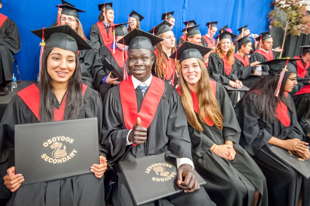 Graduates look happy after receiving their diplomas. In foreground from left are Netu Dhaliwal, Charles Nyarza and Kristi Gehringer. (Richard McGuire photo)