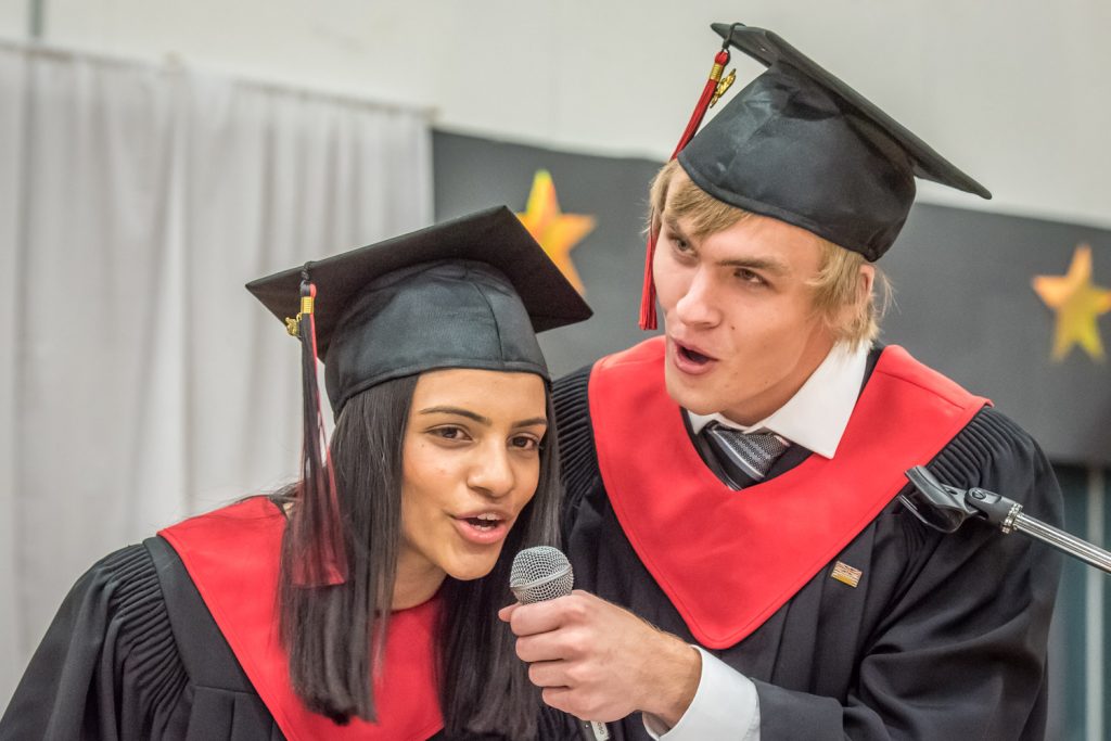 Valedictorians Parveen Chauhan and Cameron Kelm recall anecdotes from the grad class’s experiences during their valedictory address at last Thursday evening’s graduation ceremonies at Osoyoos Secondary School. A total of 43 students graduated. (Richard McGuire photo)