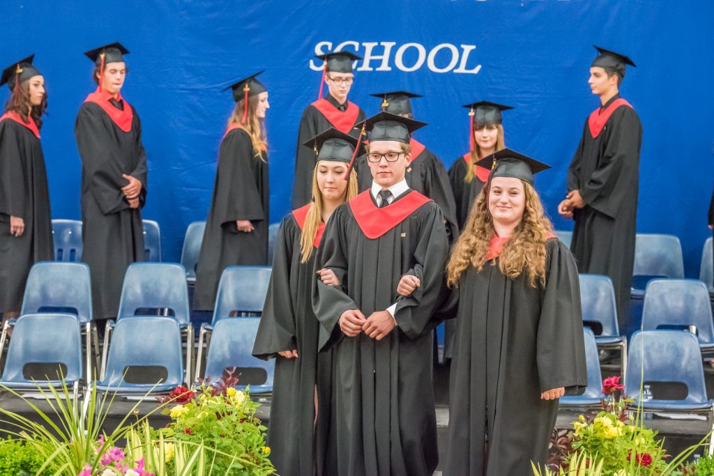 Cailyn Mocci, Nolan Zweep and Kelsey Loura leave the stage followed by fellow graduates. (Richard McGuire photo)
