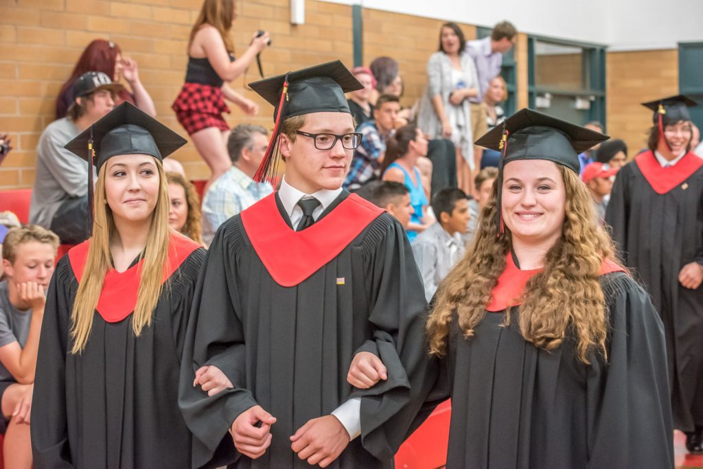 Students Cailyn Mocci, Nolan Zweep and Kelsey Loura parade through the gymnasium at the end of the ceremony. (Richard McGuire photo)