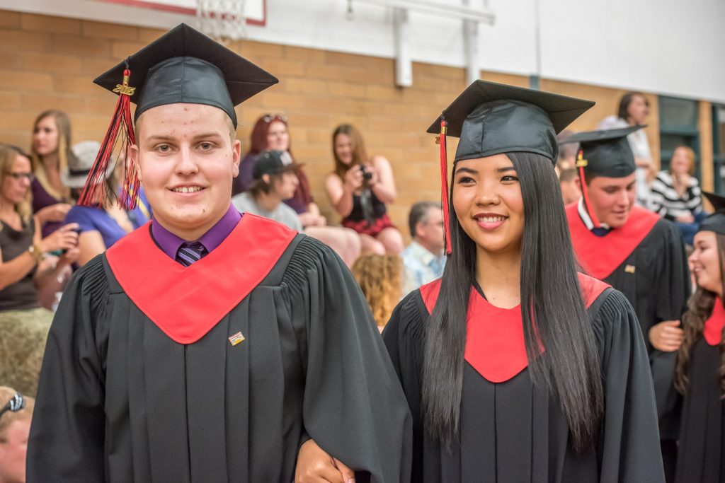 Students Shayden Stark and Pearl Cabanda parade through the gymnasium at the end of the ceremony. (Richard McGuire photo)