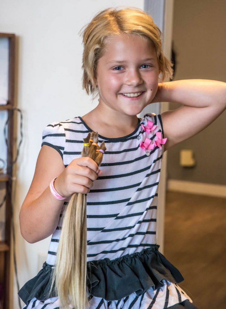 Crystal Zimmerman, 8, from Osoyoos, had the second haircut of her life in August. Her previous one was two years ago. Both times she has donated her hair to the Angel Hair for Kids program, which provides prosthetic hair pieces to financially disadvantaged children who have lost their own hair to illness. (Richard McGuire photo)