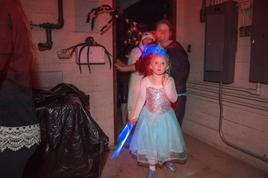 Under eerie lights, visitors tour the dungeons at the Sonora Community Centre's haunted house during Halloween Howl. (Richard McGuire photo)