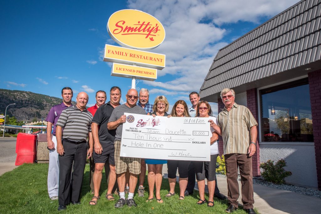 Smitty's Family Restaurant last week presented the Town of Osoyoos team with a $10,000 cheque for a hole in one hit by Ron Doucette. The town's director of operational services made the shot in June during the Rotary Club of Osoyoos annual golf tournament. Pictured from left are: Drew Bolokoski, head pro, Osoyoos Golf Club; Doug Matthews, golf committee chair, Rotary Club of Osoyoos; Lee Sapach, general manager, Osoyoos Golf Club; Jim Zakall, Team Doucette, Town of Osoyoos; Doucette; Neil Pagett, Team Doucette, Town of Osoyoos; Carol Youngberg, Team Doucette, councillor, Town of Osoyoos; Tammy Herle, Smitty's; Chris Fraser, Smitty's; Wendy Herle, Smitty's; and Wilfred Herle, Smitty's. (Richard McGuire photo)