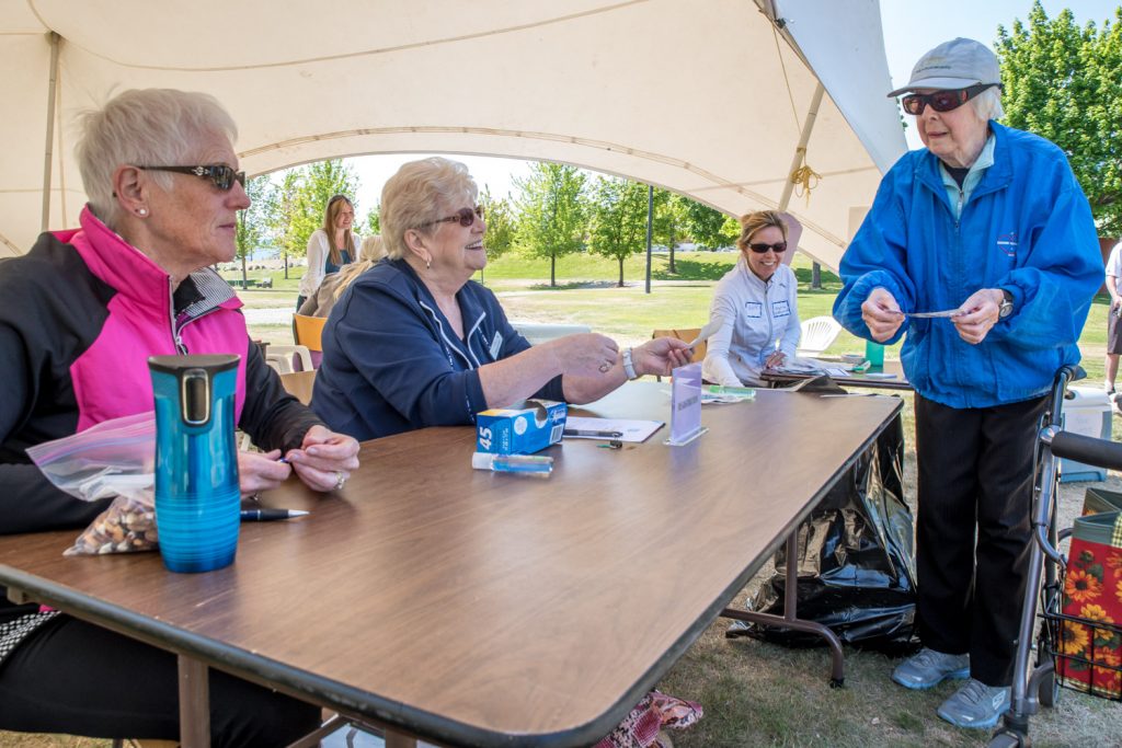 Dot Cranston (right) will turn 90 later this year, but she walked nearly two kilometres from her home with her walker to support the Desert Valley Hospice Society's Hike for Hospice event in Oliver on Sunday. Cranston brought a donation, but she planned only to watch the hikers and take some photos with her trusty film camera. At the registration table were Juleen McElgunn (left), a volunteer, and Trudy Demorest, a volunteer and board member. (Richard McGuire photo)