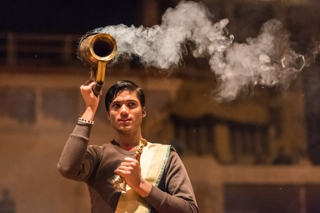 A Hindu priest performs during an evening ceremony by the Ganges River in Varanasi. (© Richard McGuire Photo)