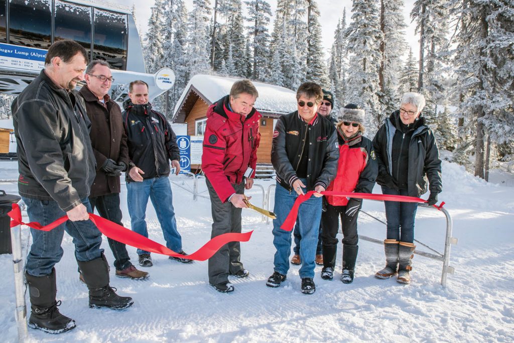 Fred Johnston, president of Baldy Capital Corporation, cut the ribbon to officially open Mount Baldy Ski Resort to the public last January. He was helped by Chief Clarence Louie, of the Osoyoos Indian Band. From left are Mark Pendergraft, chair, Regional District of Okanagan-Similkameen; Oliver Mayor Ron Hovanes; Mountain Manager Matt Koenig; Johnston; Louie; Myers Bennett, president of the South Okanagan Chamber of Commerce; Judy Miller-Bennett, president of Rotary Club of Osoyoos and wife of Bennett; and Gail Scott, managing director of Destination Osoyoos. (Richard McGuire photo)