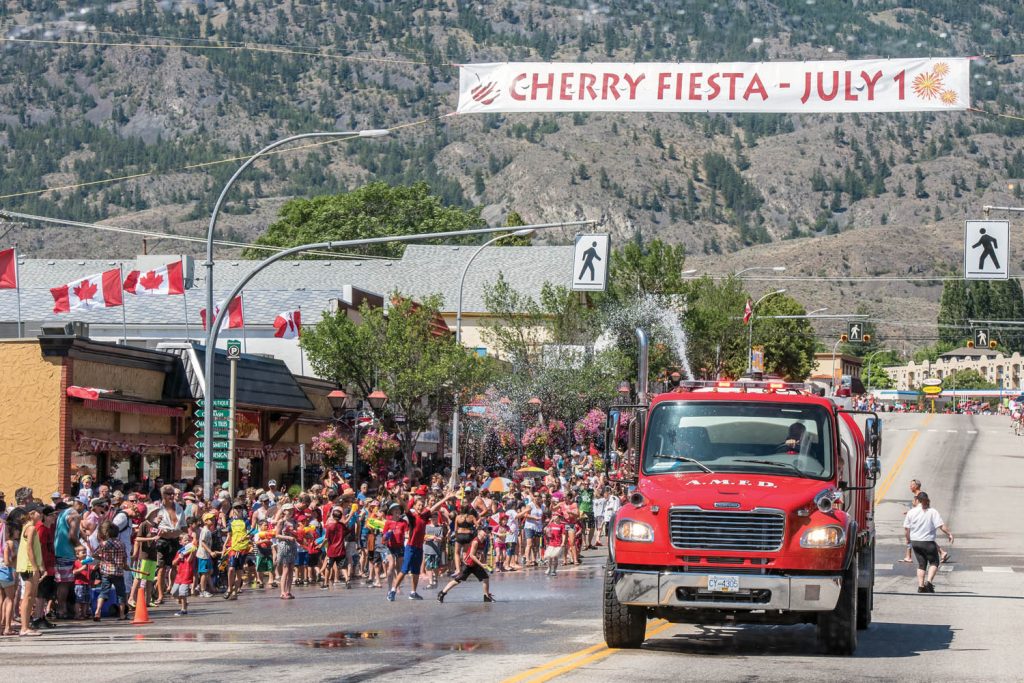 Anarchist Mountain firefighters made their way down Main Street past the attack zone for the water fight, which is in front of Osoyoos Home Hardware. The water fight is a popular highlight of Cherry Fiesta in July and gets underway just before the parade. (Richard McGuire photo)