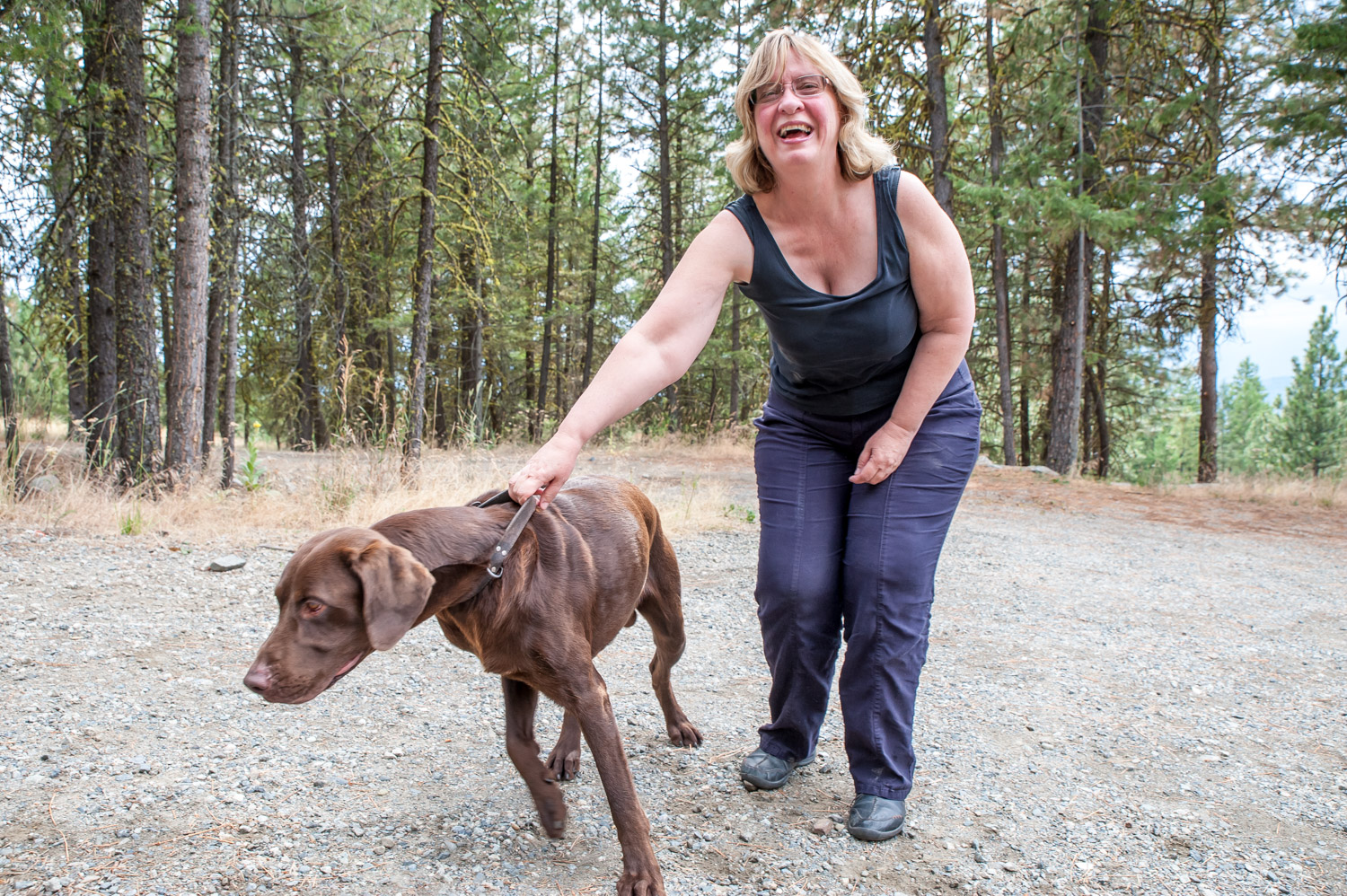 Barbara Haskell tries to control Koko for a photo, but Koko has other priorities. Koko disappeared on a walk when a woman took him and dropped him in Grand Forks. (Richard McGuire photo)