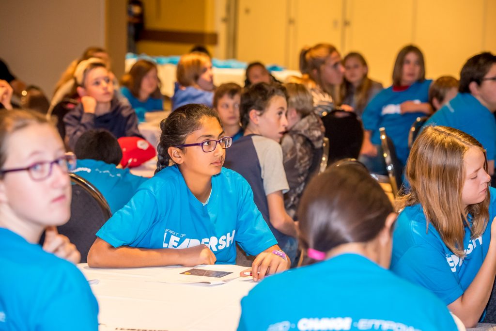 Grade 7 students from Osoyoos Elementary School listen intently as former hockey star Ryan Walter delivers a message about leadership by video. (Richard McGuire photo)