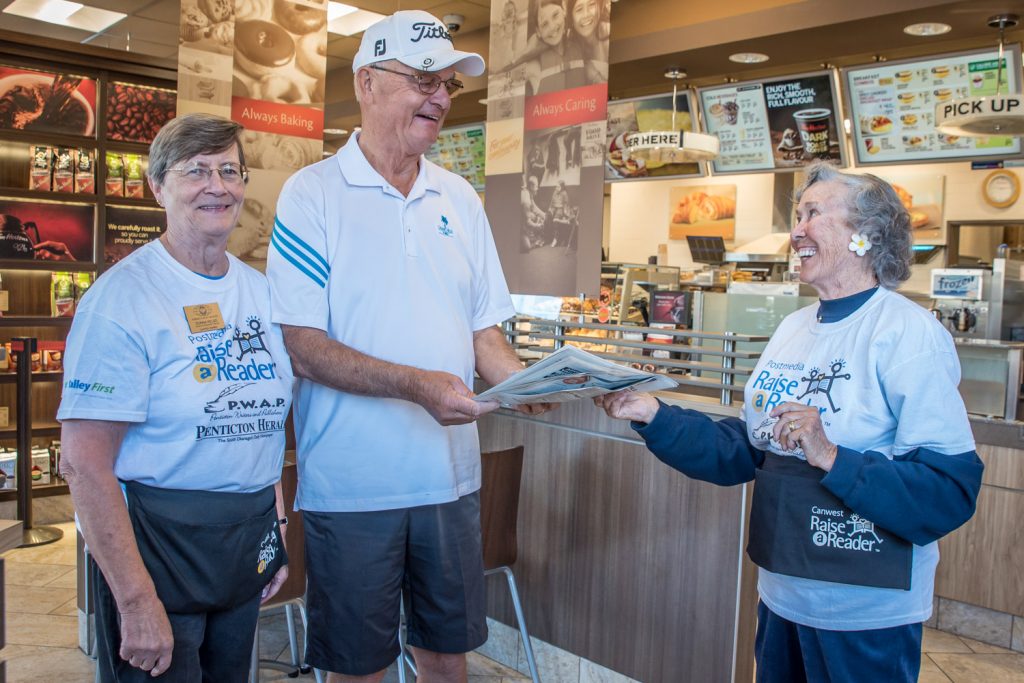 Members of the Kiwanis Club of Osoyoos were selling newspapers at Tim Hortons in Osoyoos last Wednesday to raise funds for the Raise-A-Reader literacy program. Pictured here, Donna Kelso (left) and Isobel Hart (right) gave a Penticton Herald to Walter Tymofievich of Penticton in exchange for a donation. The event was co-ordinated through Literacy Now South Okanagan-Similkameen and funds raised will directly benefit Osoyoos residents. An estimated four in 10 Canadians struggle with reading, which affects their job prospects, health care and other aspects of their lives. Promoting literacy is one of the goals of the local Kiwanis Club. (Richard McGuire photo)