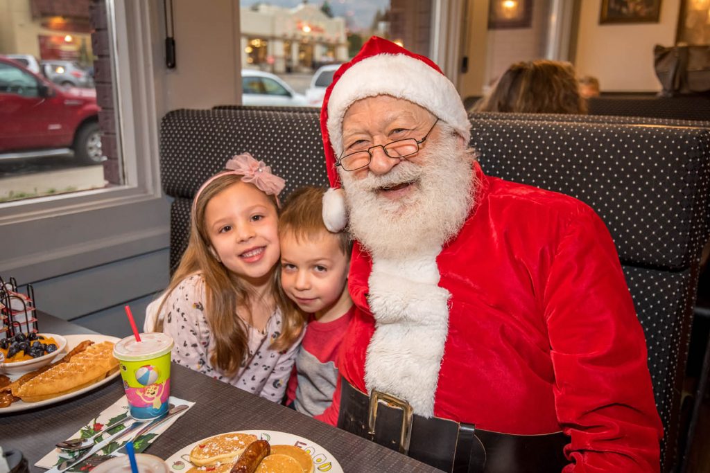 Mila (5) and Max (4) Keller were eating breakfast at Smitty's Family Restaurant in early December at the start of Osoyoos Christmas Lite-Up when Santa Claus stopped by at their table. Many local residents turned out for Smitty's Toys for Tots to Teens annual event. (Richard McGuire photo)